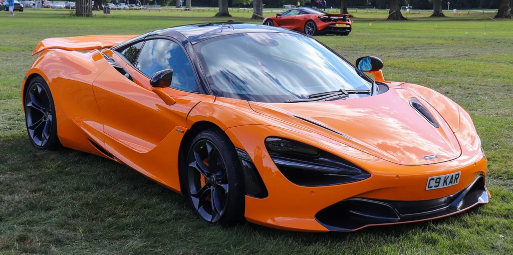 Orange McLaren 720S coupe parked beside a road