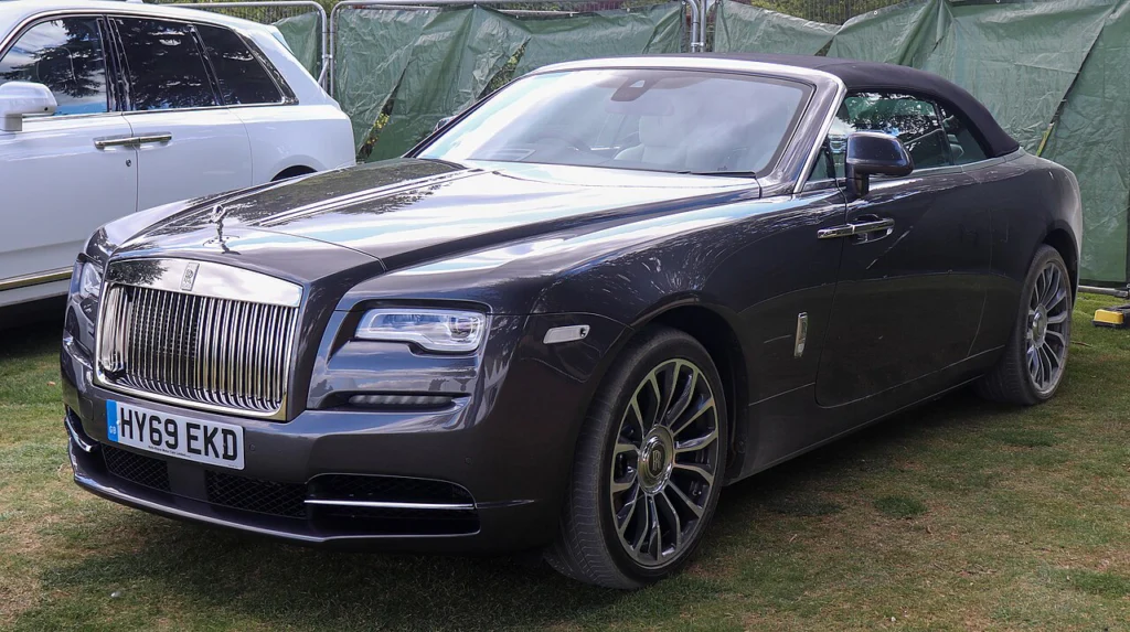 Dark blue Rolls-Royce Dawn convertible with its fabric roof raised