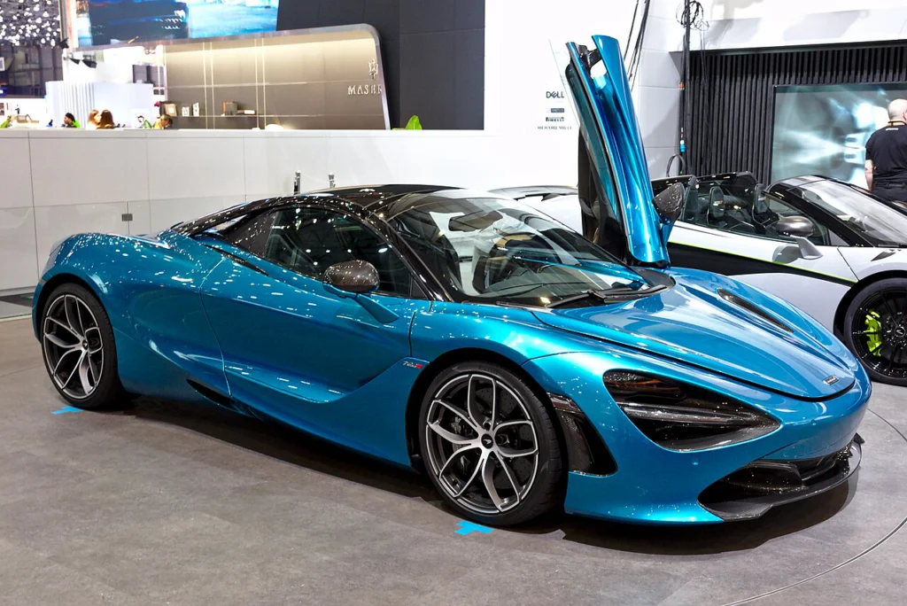 Blue McLaren 720S Spider with its roof down and door raised