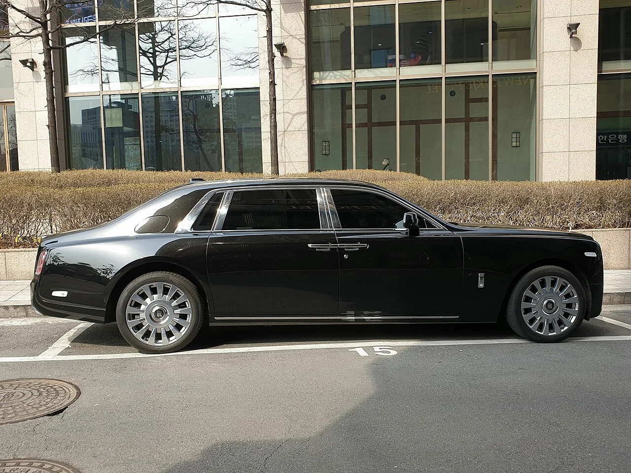 Side profile of a black Rolls-Royce Phantom VIII extended-wheelbase sedan